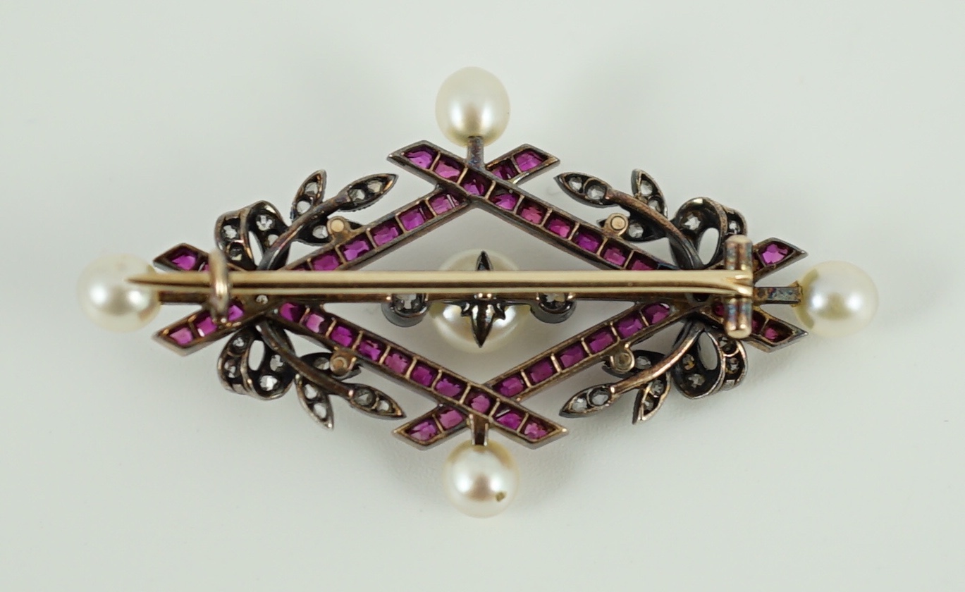 An early 20th century gold and silver, cultured pearl, ruby and diamond cluster set diamond shaped brooch